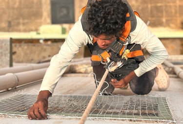 Pigeon net installation covering an apartment duct to prevent bird entry.