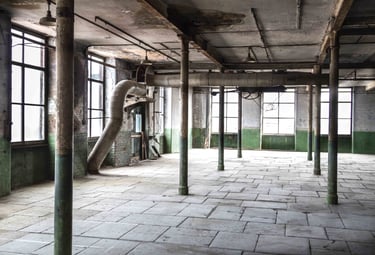 Original stone floor, industrial workings, peeling paints on walls and 6 metre tall windows in the Stone Room at Atlas Studio