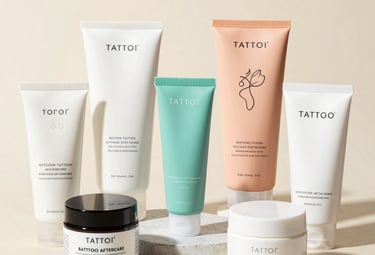 A collection of tattoo style sketches pinned on a wooden board.