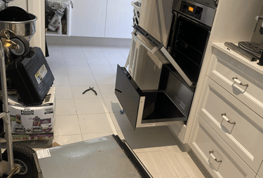 a kitchen with a microwave, oven and a warmer.