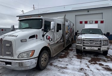Two of our ambulances at our shop including the "Monster" Kenworth ambulance