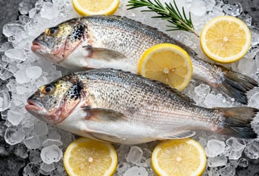 A top-down view of fresh whole sea bream on a bed of crushed ice, garnished with lemon slices and rosemary. Professional food photography with a focus on scales texture and clarity. Palette colors include Sandstone and Pale Cream.