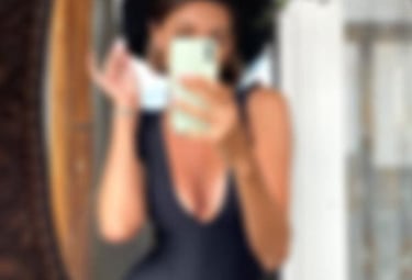 a sugar baby in a swimsuit is taking a selfie