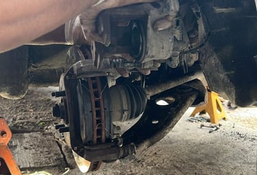 a person is working on a car's brake