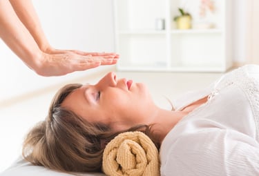 a woman is shown in a massage room sesiones de reiki