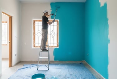 a painter is painting a wall in a room