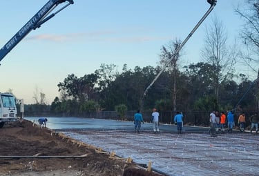 Croft Concrete boom truck and workers on a constuction site .