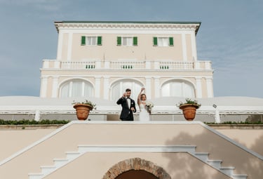 a bride and groom standing on a staircase way