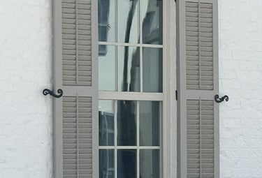hinged exterior shutters that open and close