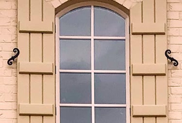 arched top exterior board and batten shutters