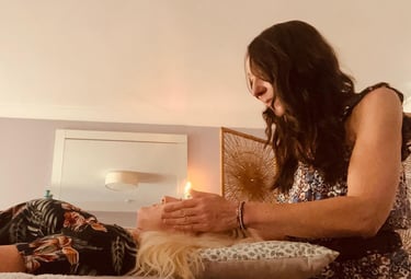Liv giving reiki to a lady; her hands around her head