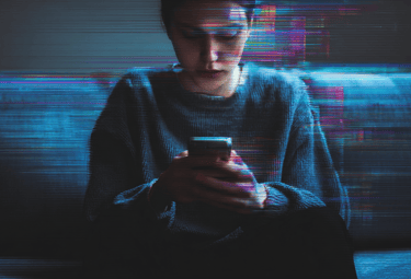 a man in a sweater sitting on a couch