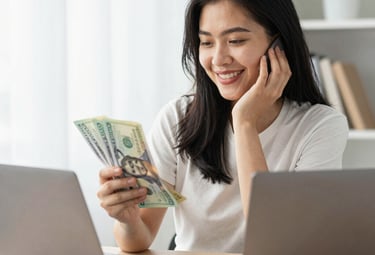 person holding fan of us dollar bill