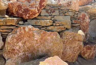 Limestone boulders & veneer stonework with hidden mortar—engineered strong yet appears fully natural