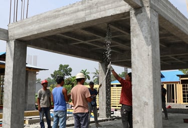 Construction workers building a modern house structure on site.