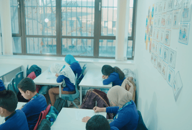 Students receiving guidance from a tutor at a private exam centre for Excel certification.