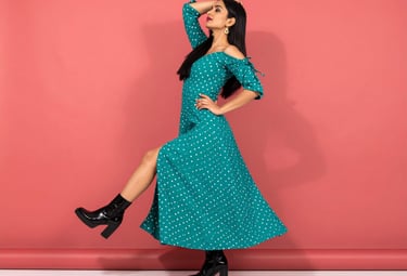 a woman in a polka dot dress with a polka dot print dress