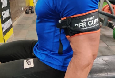 atient performing a leg press exercise with BFR cuffs applied, by Dr. Piyush Jain at the Galene