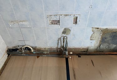Pipework exposed to allow it to be re-laid for a new basin and toilet