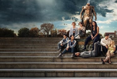 a group of people sitting on steps with a statue of a man