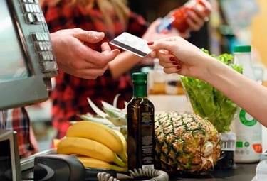 a person is paying a purchase at a grocery store
