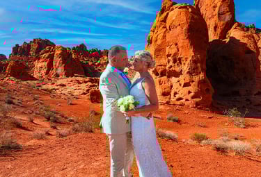 a man and woman standing in front of a mountain