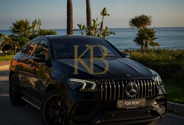 Luxury black Mercedes AMG SUV for rent parked near the beach with palm trees in Marbella.
