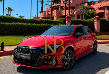 Red Audi RS3 luxury car rental parked in front of a Mediterranean villa in Marbella.