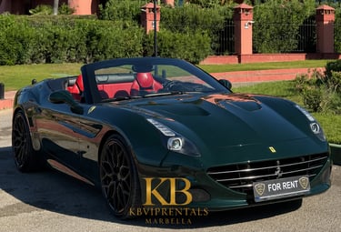 A dark green Ferrari California convertible with red leather interior parked at a luxury rental in Marbella.