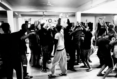Group dance and movement therapy session with residents celebrating together in the activity hall.