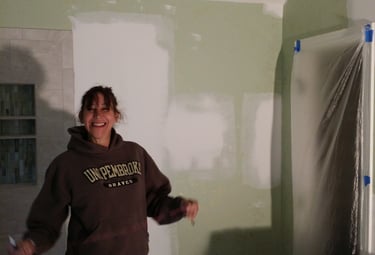 Janet Graybill showing off her work with a smile.