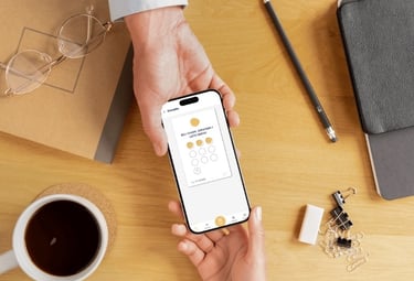 a person handing a phone with a digital loyalty card