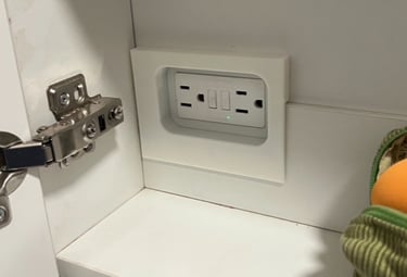 3d printed cover over electrical outlet in bathroom cupboard