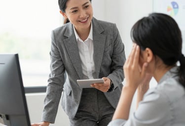 A compassionate business consultant speaking with a relieved client in a bright, welcoming office.