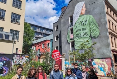 Street art mural in Hamburg with “Stay with the trouble” and group, Graffiti und urbane Kunst Szene in der Stadt