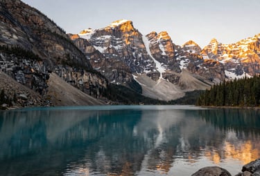 The Canadian Rockies with a crystal clear lake, representing stability and growth. Professional landscape photography with elegant gold lighting.