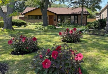 Andy Albright's garden planning example with a house in the background and his flower arrangements