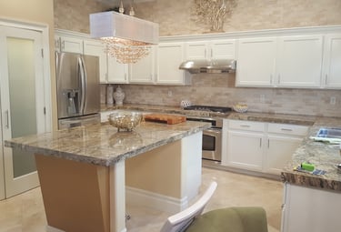 Refinished kitchen cabinetry from brown wood to white lacquer