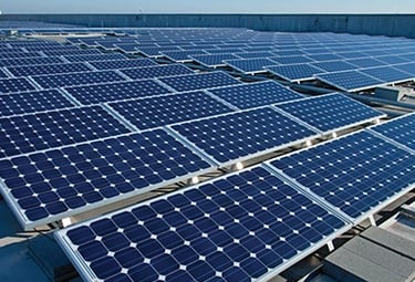 Photovoltaic solar panels installed on a flat commercial rooftop for renewable energy production.