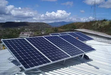 Photovoltaic solar panels installed on a residential metal roof for renewable energy.