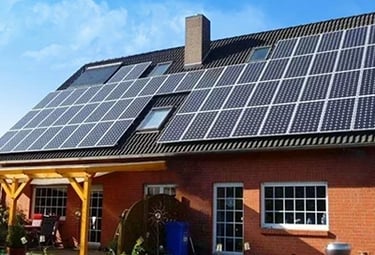 Residential brick house with rooftop solar panels installed for renewable energy efficiency.