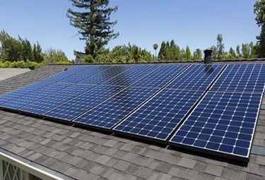 A residential rooftop solar panel installation for renewable energy efficiency on a sunny day.