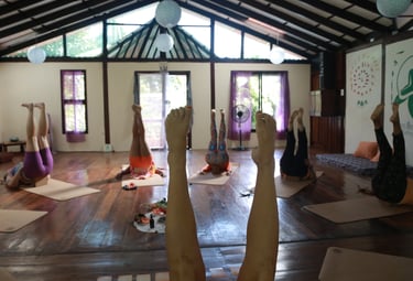 a group of people doing yoga exercises in a room