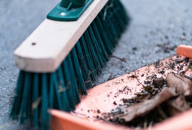 Broom sweeping debris
