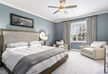 a bedroom with a bed and a couch