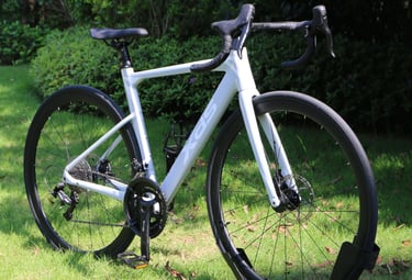XDS AD350 road bike with disc brakes parked on a green grass lawn.