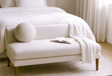 Compact linen settee in a cozy reading corner with natural shadows, a book, and a warm light atmosphere.