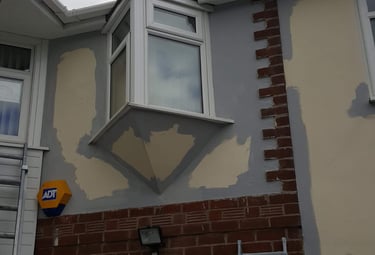a house exterior being primed for painting
