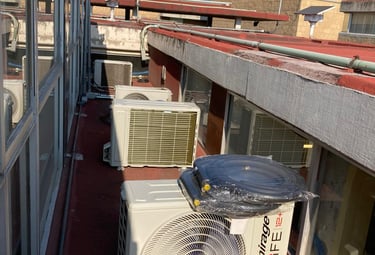 a couple of air conditioners sitting on a roof top