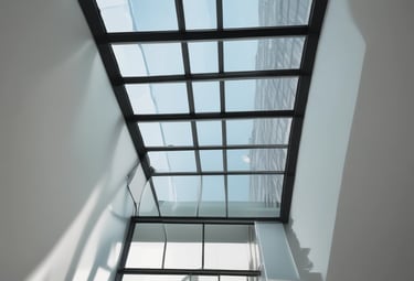 Close-up of a sparkling clean commercial glass facade reflecting the sky.